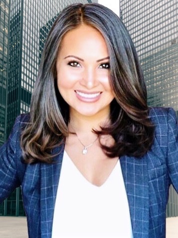 A woman in a blue jacket smiling for the camera.